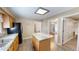 Bright kitchen with center island, stainless appliances, and wood cabinets; view of dining area at 772 Old Allensville, Roxboro, NC 27574
