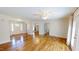 Open living area with hardwood floors, multiple doorways, and a ceiling fan at 772 Old Allensville, Roxboro, NC 27574