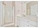 Clean white bathroom with sleek vanity, framed mirror, and glass-enclosed shower at 7819 Acc Blvd, Raleigh, NC 27612