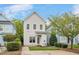 Exterior showcasing a two-story home with white siding, a well-kept lawn, and a paved walkway at 7819 Acc Blvd, Raleigh, NC 27612