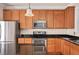 Close-up of kitchen appliances, custom cabinets, and granite countertops with stainless appliances at 7819 Acc Blvd, Raleigh, NC 27612