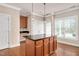 Eat-in kitchen featuring a granite island, ample storage, and a hardwood floor at 7819 Acc Blvd, Raleigh, NC 27612
