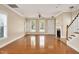 Inviting living room with hardwood floors, fireplace, natural light, and view of the staircase at 7819 Acc Blvd, Raleigh, NC 27612