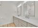 Bathroom features double sink vanity with white countertops and a large mirror at 8 Nottingham Pl, Smithfield, NC 27577