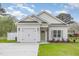 Charming single-Gathering home with white siding, green door and well-manicured lawn at 8 Nottingham Pl, Smithfield, NC 27577