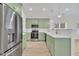 Bright kitchen features green cabinets, stainless steel appliances, white countertops, and modern fixtures at 8 Nottingham Pl, Smithfield, NC 27577