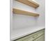 A close-up on the countertops and shelving of the laundry area with gold hardware at 8 Nottingham Pl, Smithfield, NC 27577