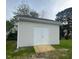 The shed features white siding and a double door entry, providing great yard storage and functionality at 8 Nottingham Pl, Smithfield, NC 27577