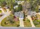 Aerial view of a home featuring a well-manicured lawn, mature trees, and a long driveway at 801 Noconia Pl, Fuquay Varina, NC 27526