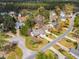 Scenic aerial view of a neighborhood featuring lush greenery, well-kept homes, and well-maintained streets at 801 Noconia Pl, Fuquay Varina, NC 27526