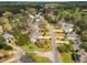 Scenic aerial view of a neighborhood featuring lush greenery, well-kept homes, and well-maintained streets at 801 Noconia Pl, Fuquay Varina, NC 27526