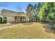 Spacious backyard with lush green grass, mature trees, and the home's screened-in porch at 801 Noconia Pl, Fuquay Varina, NC 27526