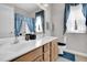 Bathroom with a double sink vanity, blue-themed decor, and plenty of natural light at 801 Noconia Pl, Fuquay Varina, NC 27526