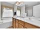 Bathroom featuring double sink vanity, large mirror, and window with privacy glass at 801 Noconia Pl, Fuquay Varina, NC 27526