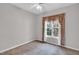 Cozy bedroom with a neutral color scheme and natural light shining through the large window at 801 Noconia Pl, Fuquay Varina, NC 27526