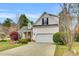 Charming home featuring a manicured lawn, two car garage, and architectural roof at 801 Noconia Pl, Fuquay Varina, NC 27526