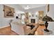 Open living area with fireplace and view of the breakfast bar, hardwood floors, and natural light at 801 Noconia Pl, Fuquay Varina, NC 27526