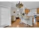 Open living area features breakfast bar, hardwood floors and stained glass light fixture at 801 Noconia Pl, Fuquay Varina, NC 27526