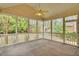 Enclosed screened porch with a ceiling fan provides a relaxing outdoor living space with backyard views at 801 Noconia Pl, Fuquay Varina, NC 27526