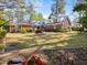 Expansive backyard with mature trees, a swing set, and a garden at 806 S First St, Smithfield, NC 27577