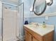 Bathroom with modern shower, vanity with sink, modern fixtures, and neutral blue walls at 806 S First St, Smithfield, NC 27577