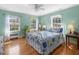 Airy bedroom with light blue walls, hardwood floors, and ample natural light at 806 S First St, Smithfield, NC 27577