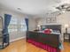Comfortable bedroom features hardwood floors, a ceiling fan, and natural light from the window at 806 S First St, Smithfield, NC 27577