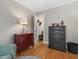 Bedroom with wooden floors features a red and a black wooden chest of drawers at 806 S First St, Smithfield, NC 27577