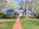 Charming brick home with blue shutters, well-manicured lawn, and a welcoming brick walkway at 806 S First St, Smithfield, NC 27577