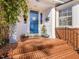 Charming brick porch with blue door, beautiful plants, and a welcoming entrance at 806 S First St, Smithfield, NC 27577