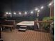 Backyard hot tub featuring string lights and wood surround at 806 S First St, Smithfield, NC 27577