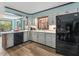 Bright kitchen featuring white cabinets, stainless steel appliances, and wood look flooring at 806 S First St, Smithfield, NC 27577