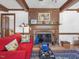 Comfortable living room features a fireplace and a red couch at 806 S First St, Smithfield, NC 27577