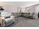 Large living room featuring a sizable sectional couch, neutral carpet, and bay window at 806 S First St, Smithfield, NC 27577