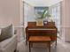Corner of living room with piano, sheer curtains, and view of outdoor greenery at 806 S First St, Smithfield, NC 27577