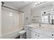 Fresh bathroom with a shower-tub combo, white vanity, and great lighting at 8700 Leeds Forest Ln, Raleigh, NC 27615