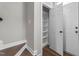 Hallway with hardwood floors showcases a storage closet and a door to the outside at 8700 Leeds Forest Ln, Raleigh, NC 27615