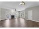 Large living room with hardwood floors, fireplace, ceiling fans, and access to outdoor patio at 8700 Leeds Forest Ln, Raleigh, NC 27615