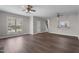 Bright living room features hardwood floors, ceiling fans, and a convenient kitchen pass-through at 8700 Leeds Forest Ln, Raleigh, NC 27615