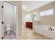 Bathroom area with tile floors, tub, vanity with sink, and toilet at 8932 Buffalo Gourd Ln, Angier, NC 27501
