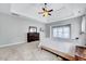 Large bedroom featuring carpet, light colored walls, ceiling fan, and a dresser with mirror at 8932 Buffalo Gourd Ln, Angier, NC 27501