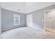 This bedroom features neutral walls and carpeting plus a window and closet at 8932 Buffalo Gourd Ln, Angier, NC 27501