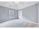 Cozy bedroom features a vaulted ceiling, neutral paint, double closet, plush carpeting, and a window at 8932 Buffalo Gourd Ln, Angier, NC 27501