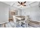 Well-lit dining room area featuring hardwood floors, modern lighting, and neutral wall colors at 8932 Buffalo Gourd Ln, Angier, NC 27501