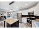 Modern kitchen features stainless steel appliances, a center island with a granite countertop, and stylish pendant lighting at 8932 Buffalo Gourd Ln, Angier, NC 27501