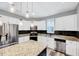 Modern kitchen featuring white cabinets, stainless steel appliances, granite countertops, and center island at 8932 Buffalo Gourd Ln, Angier, NC 27501