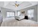 Spacious main bedroom with a tray ceiling, neutral colors, plush carpeting and ample natural light at 8932 Buffalo Gourd Ln, Angier, NC 27501