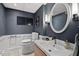 Stylish bathroom featuring beadboard detail, modern fixtures, and an oval mirror at 927 Ferncrest Dr, Durham, NC 27705