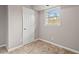 Cozy bedroom featuring tiled floor, neutral walls, and natural light from a window at 927 Ferncrest Dr, Durham, NC 27705