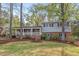 Charming two-story home with brick facade, white trim, a covered porch and beautiful landscaping at 927 Ferncrest Dr, Durham, NC 27705